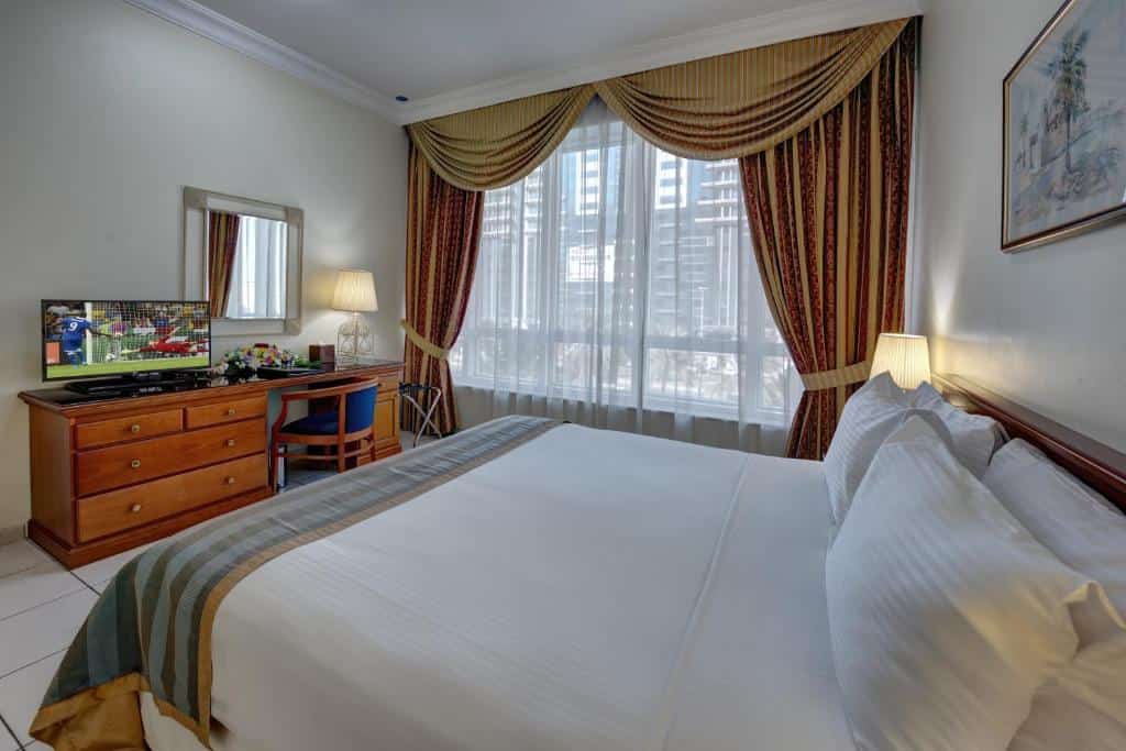 Bedroom with TV and a view at Al Nakheel Hotel Apartments, Abu Dhabi