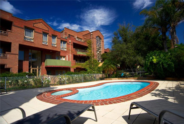 Exterior view with pool at Comfort Apartments Royal Gardens in Melbourne