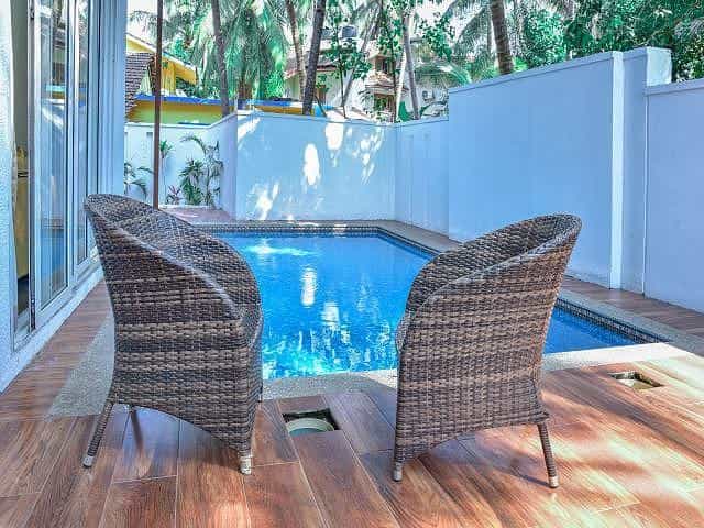 Swimming pool and chair at The Eternal Wave apartment in Calangute